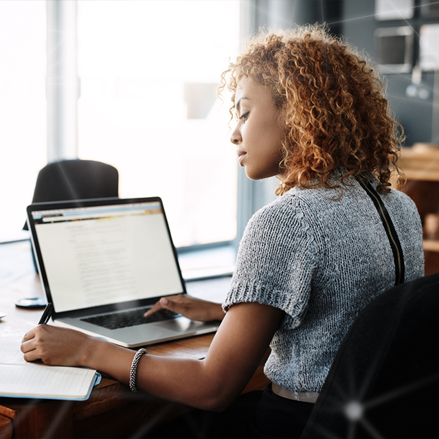 A Woman Using Her Laptop in an Office