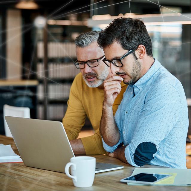 Two Men Looking at Breach Response Plans on a Laptop