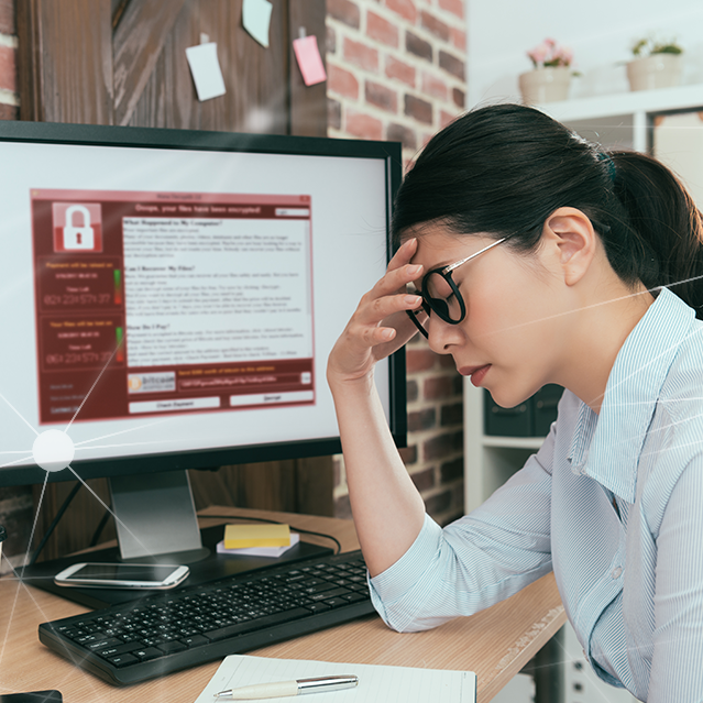 Woman looking stressed and dealing with a cyberattack