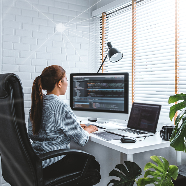 A Woman Coding at Her Desk