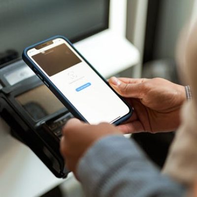 A person uses face ID to complete a transaction from their smart phone.